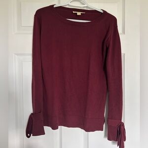 Red crew neck sweater with bow sleeve detail